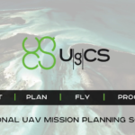 Promotional graphic for UgCS professional UAV mission planning software. The image features an aerial view of a coastal landscape with turquoise water and sandbanks in the background. The UgCS logo appears prominently in the centre. A black banner across the image contains the workflow steps: “IMPORT | PLAN | FLY | PROCESS.” Text at the bottom reads: “PROFESSIONAL UAV MISSION PLANNING SOFTWARE.