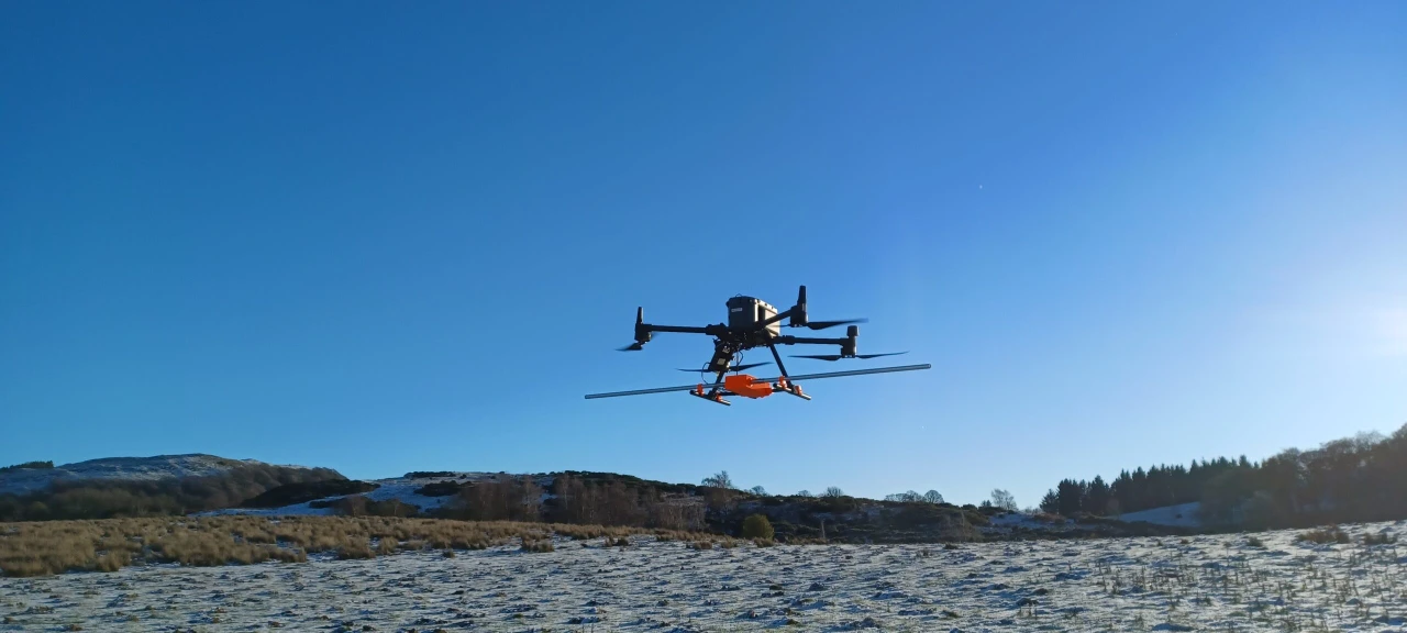 Ground Penetrating Radar sensor attach to a drone, in flight.