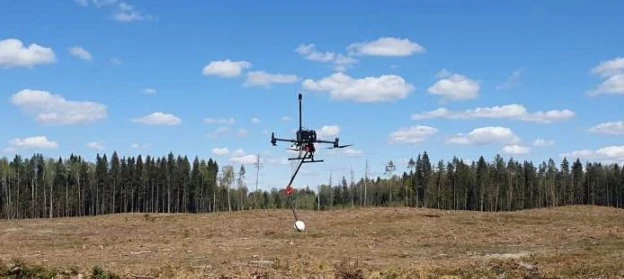 A QSPIN gradiometer system suspended beneath a professional survey drone,.