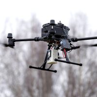 The Falcon Plus System Methane Mapper is mounted beneath a professional survey drone, providing airborne methane detection and gas leak monitoring during UAV inspection operations.