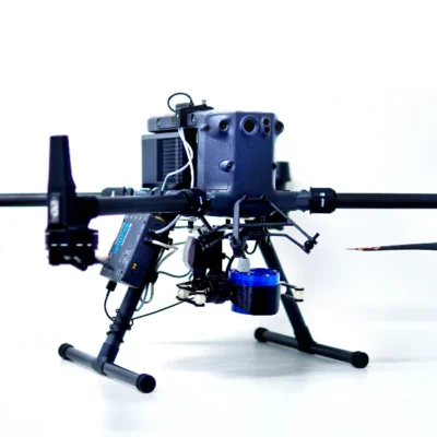 The geolux LX 80 AB 900 sensor is attached to a quadcopter drone. The drone has been photographed in a studio setting with a white background.