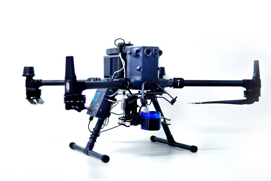 The geolux LX 80 AB 900 sensor is attached to a quadcopter drone. The drone has been photographed in a studio setting with a white background.