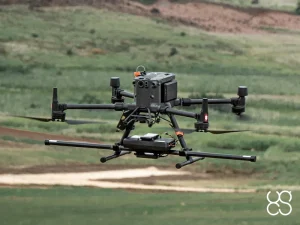 SENSYS MagDrone R3 Airborne Magnetometer System A multi-rotor drone carrying a SENSYS MagDrone R3 magnetometer payload flying over open countryside during a geophysical surveying operation.